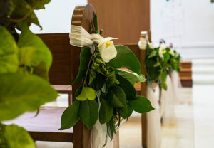 Greenery attached to pew ends
